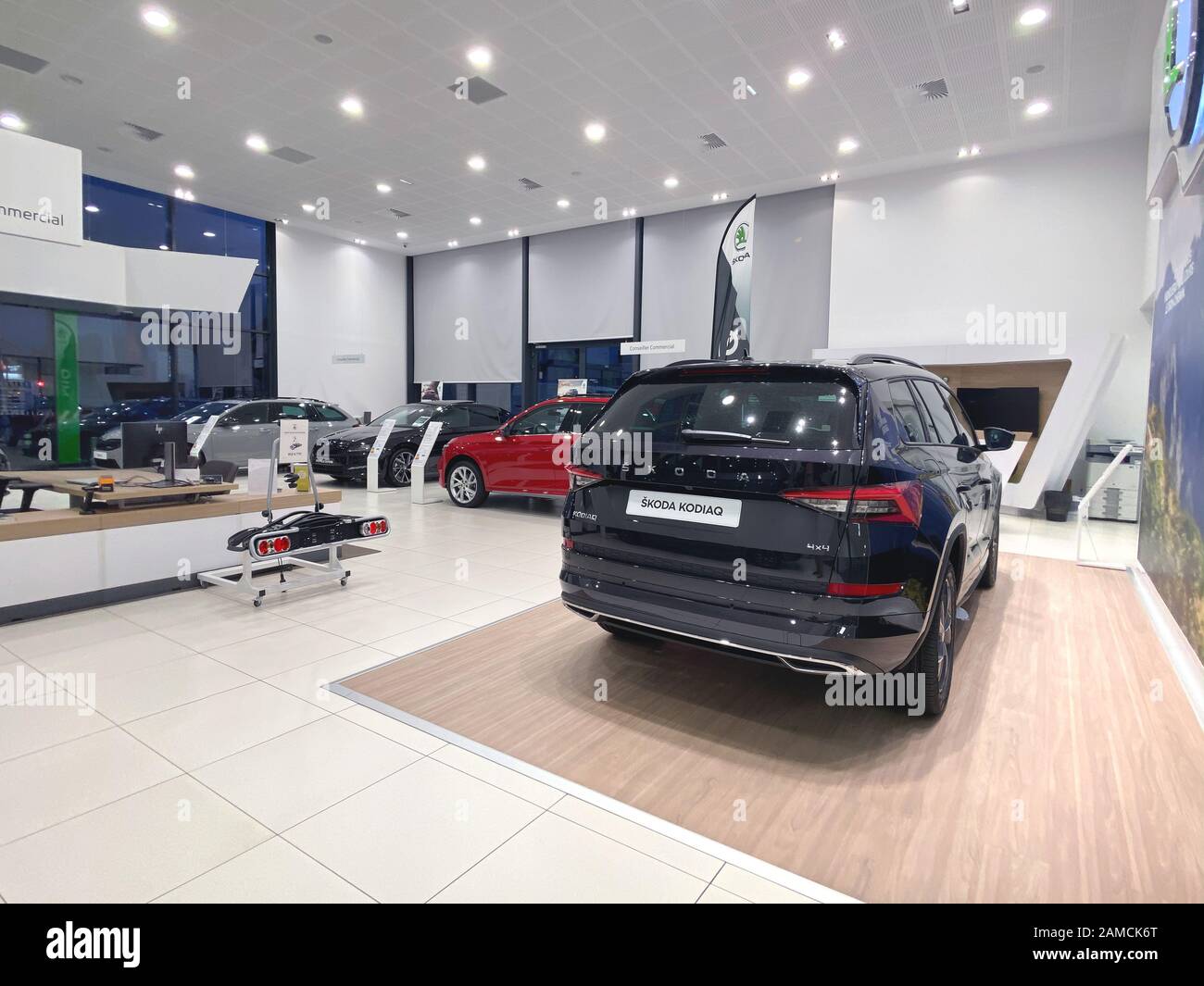 Paris, France - Oct 25, 2019: Wide angle view of car dealership showroom interior with multiple Skoda Cars inside and focus on black Skoda Kodiaq 4x4 SUV Stock Photo