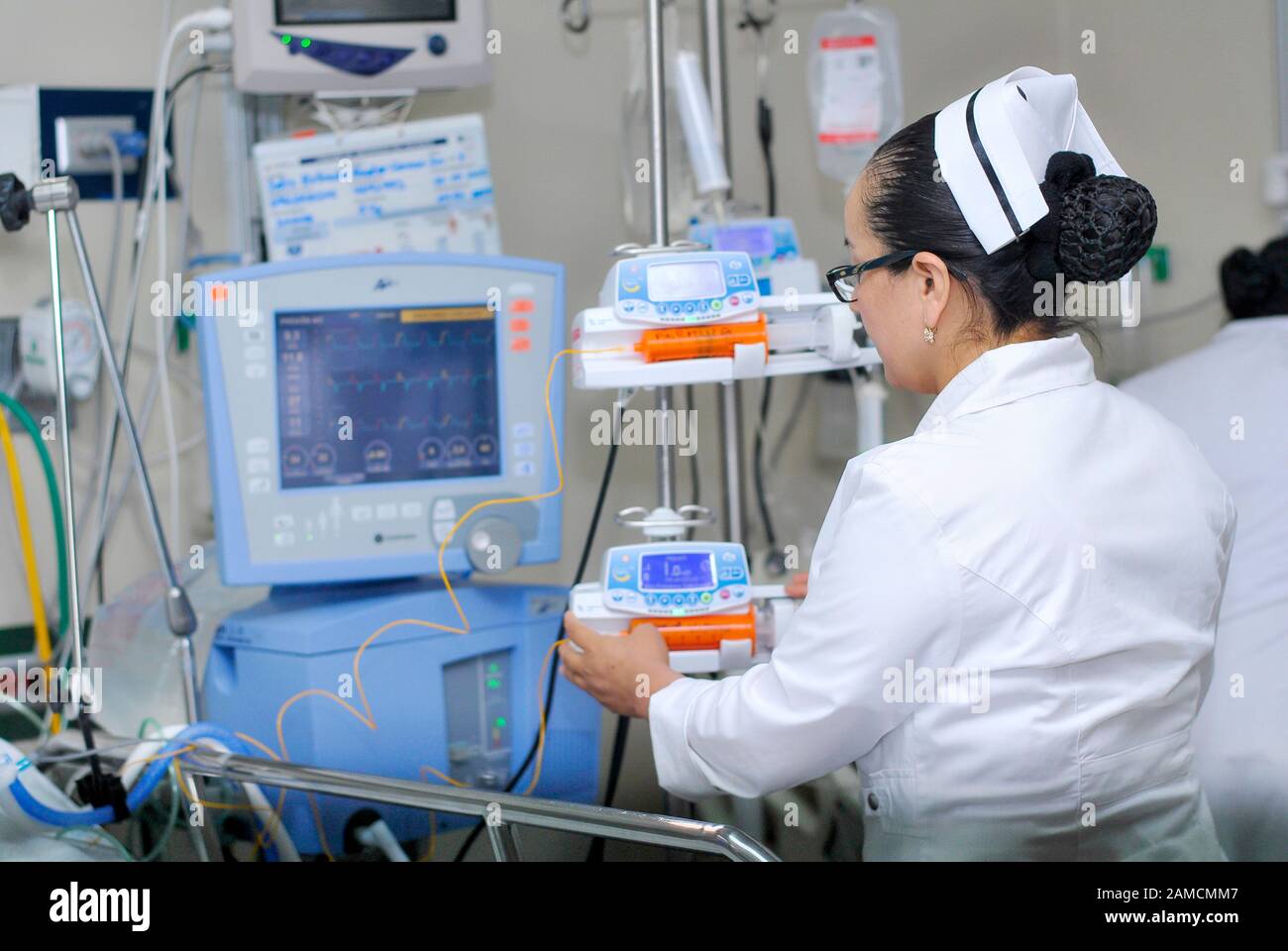 A nurse installing medication in infusion pump.  Pediatric Hospital. Guayaquil.  Ecuador Stock Photo