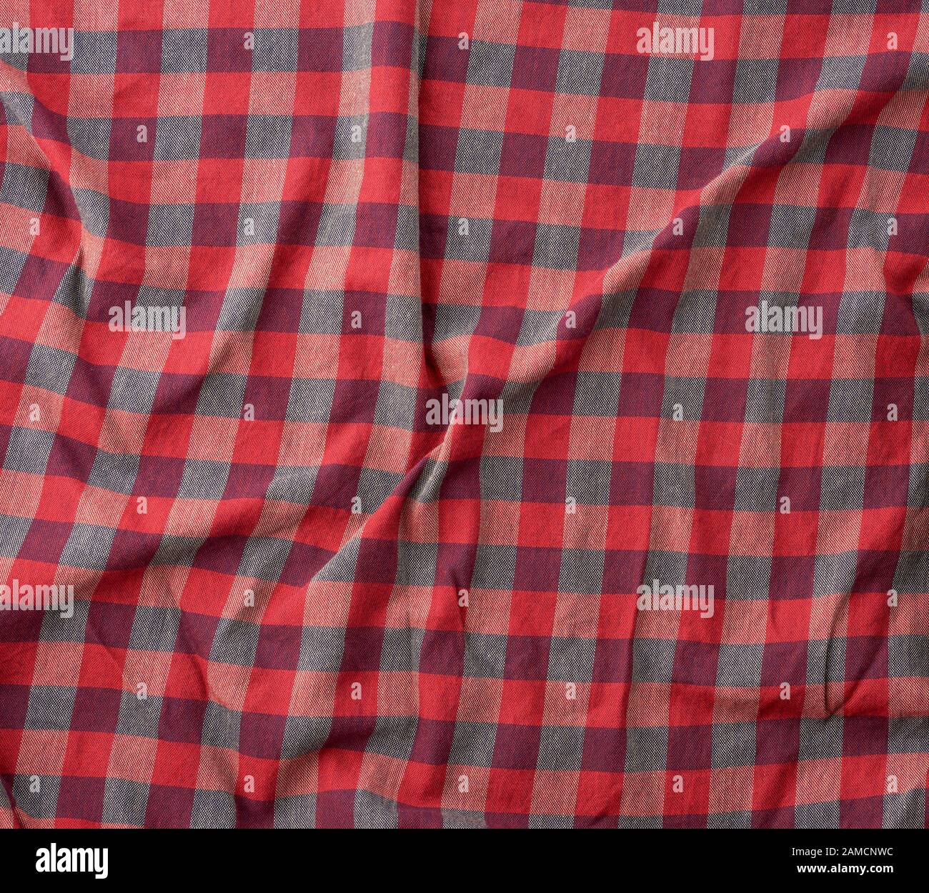 red checkered fabric for sewing various clothes with waves, full frame Stock Photo