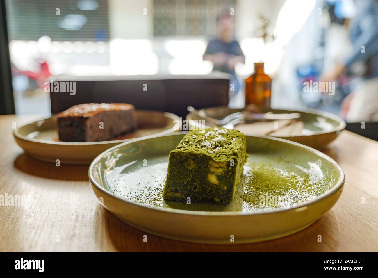 One Piece Of Minimal Matcha Brownie On Ceramic Dish And Wooden Table And Blur Background Of Other Chocolate Brownie And Sunny Atmosphere Outside Cafe Stock Photo Alamy