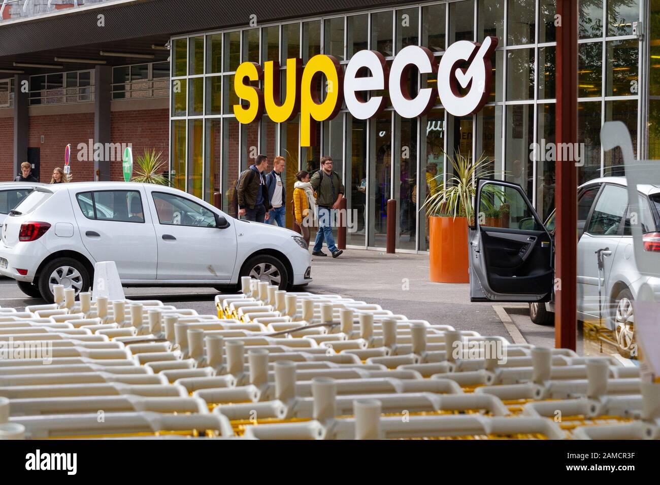 Rows of yellow branded shopping trolleys (carts) at a SUPECO supermarket in France. Stock Photo