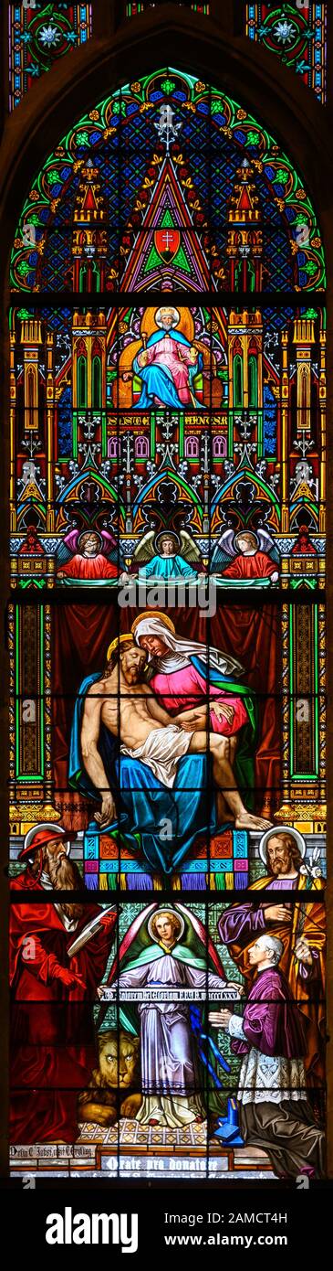 Stained glass window depicting the Pieta – the Grieving Virgin Mary holding her dead Son Jesus Christ in her arms. St Martin's Cathedral, Bratislava. Stock Photo