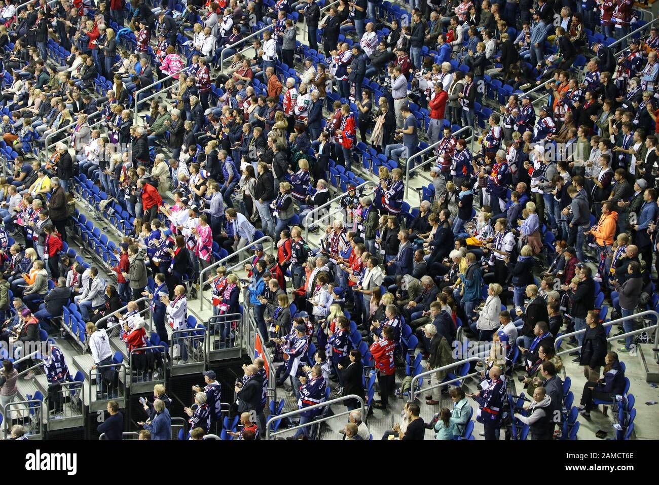 BERLIN, GERMANY - SEPTEMBER 22, 2017: Ice-hockey supporters watch the game of Deutsche Eishockey Liga (DEL) between Eisbaren Berlin and Kolner Haie on the tribunes of Mercedes-Benz Arena in Berlin Stock Photo