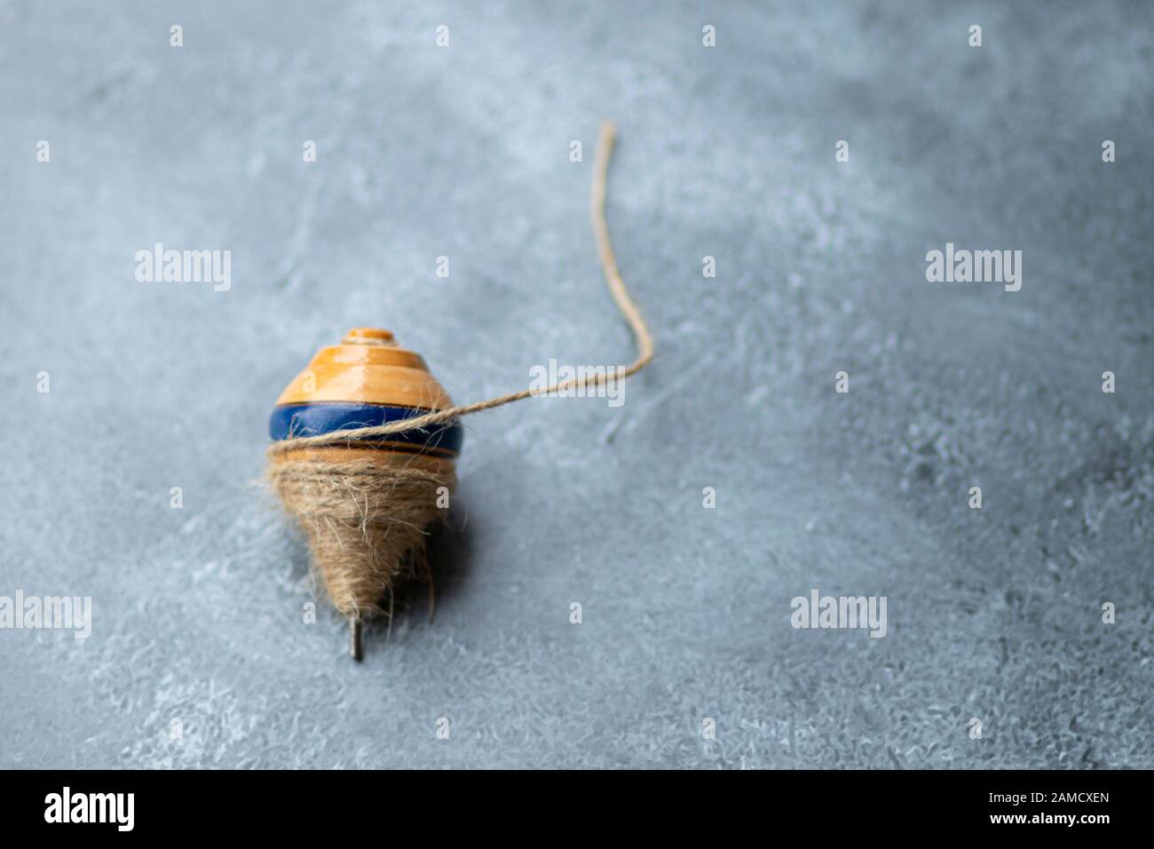 Classic wooden spinning top toy with string Stock Photo Alamy