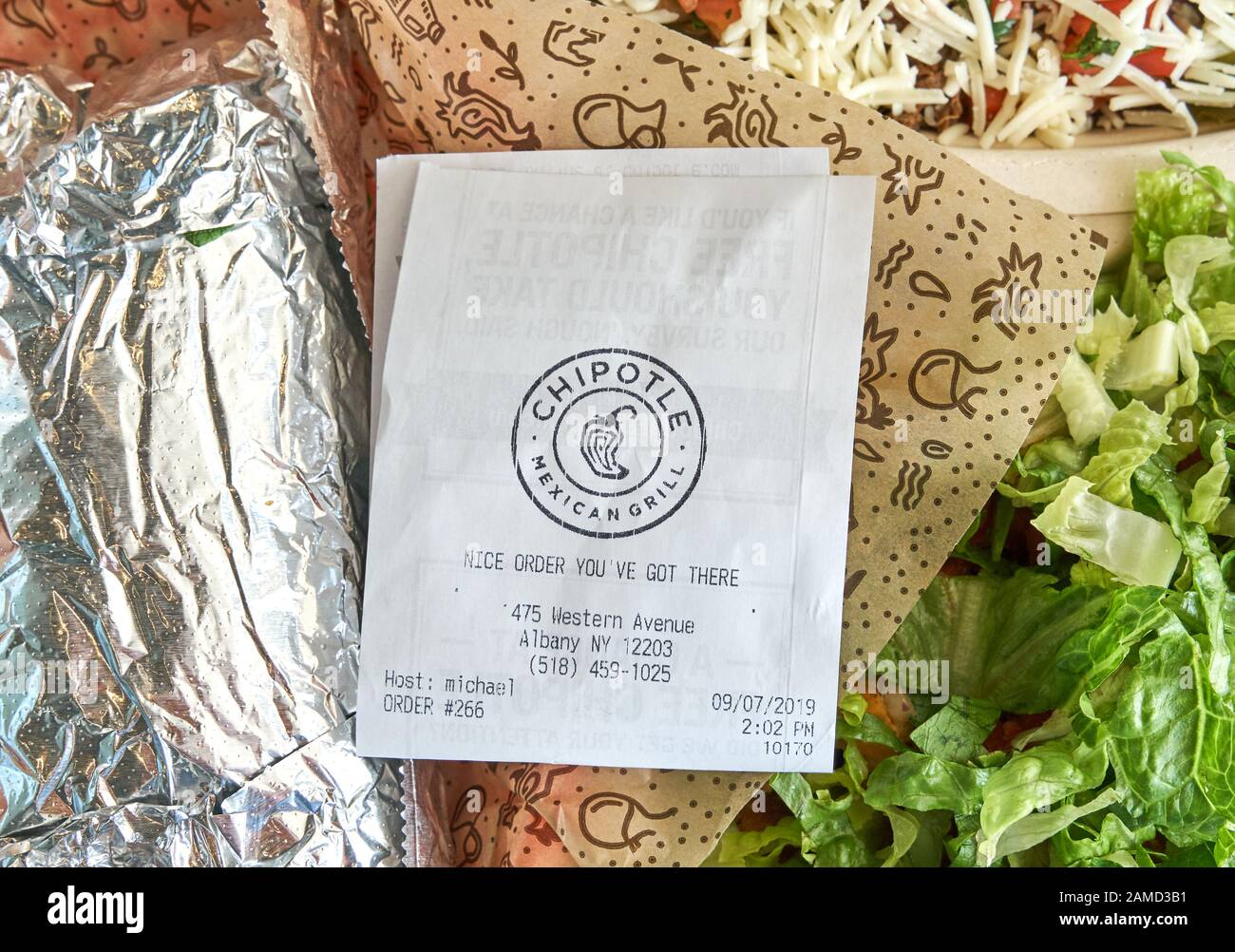 Montreal, Canada - September 7, 2019: Chipotle plate and receipt with salad. Chipotle, is an American chain of fast casual restaurants specializing in Stock Photo