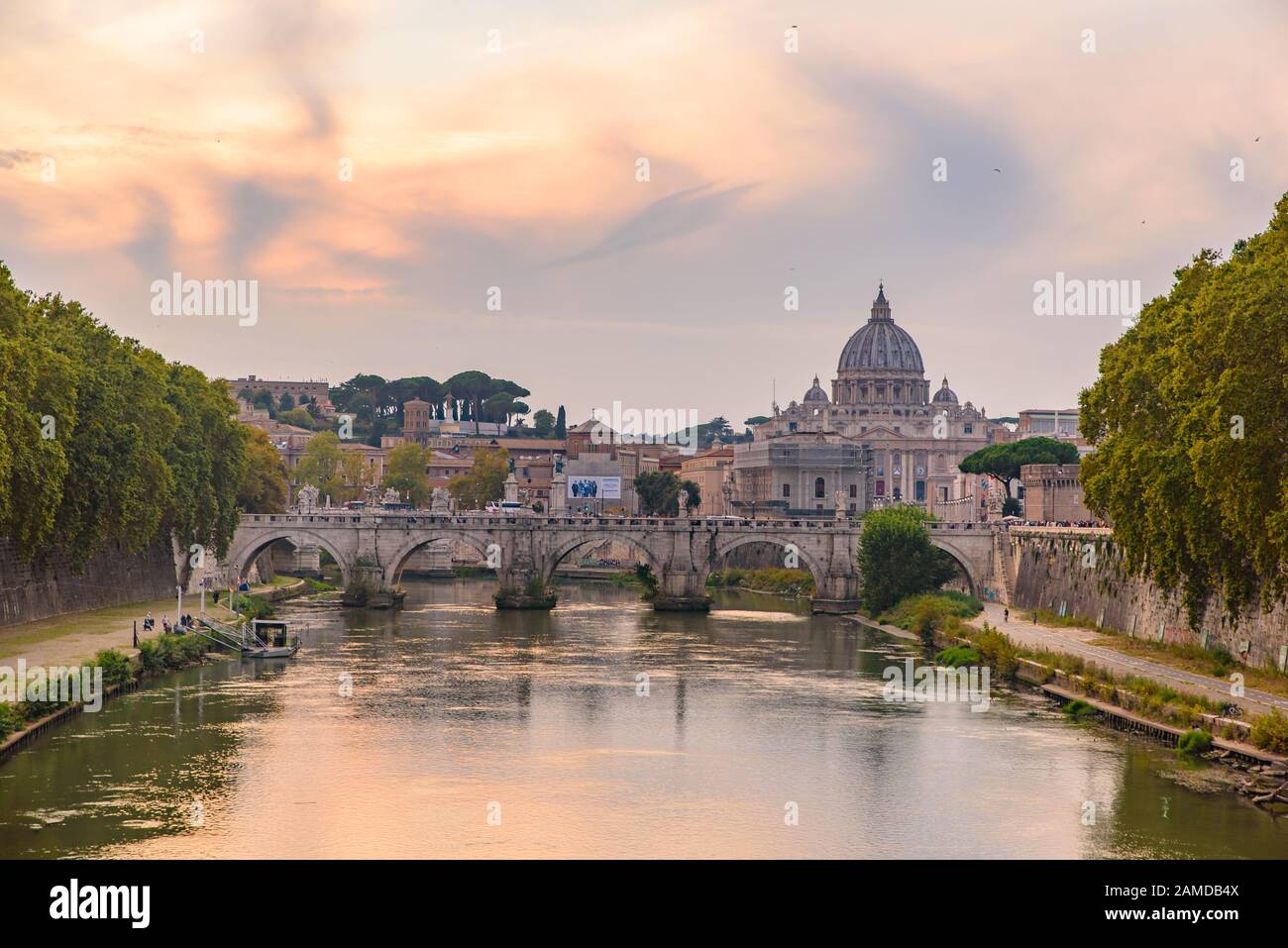 Sunset view of St. Peter's Basilica, Ponte Sant'Angelo, and Tiber River in Rome, Italy Stock Photo
