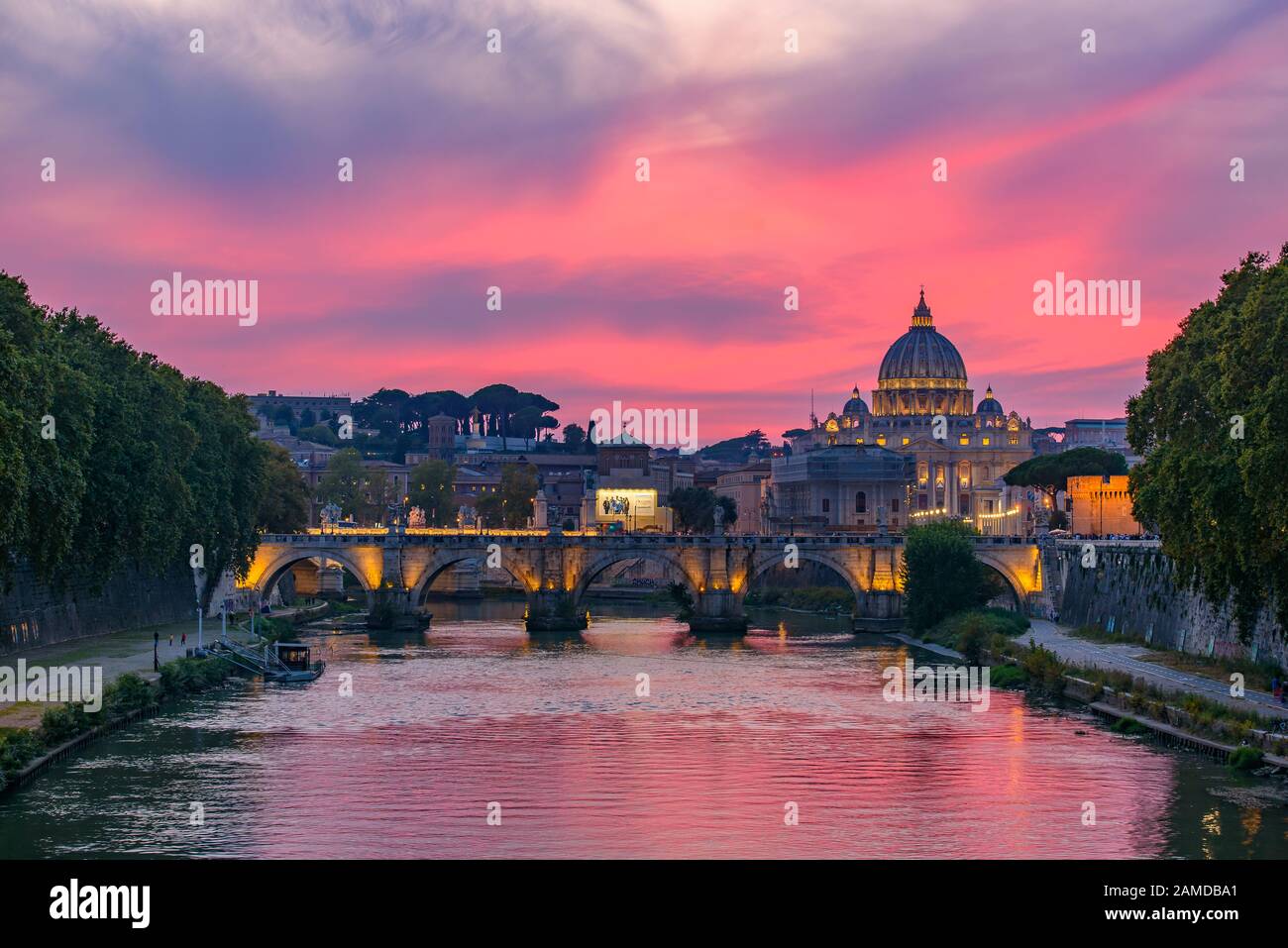 Sunset view of St. Peter's Basilica, Ponte Sant'Angelo, and Tiber River in Rome, Italy Stock Photo
