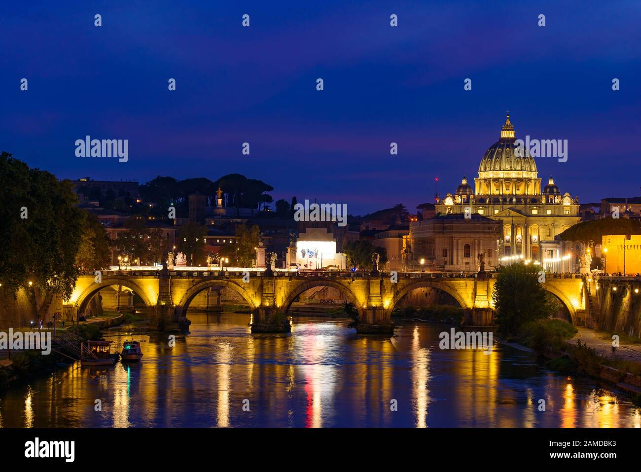 Night view of St. Peter's Basilica, Ponte Sant'Angelo, and Tiber River in Rome, Italy Stock Photo