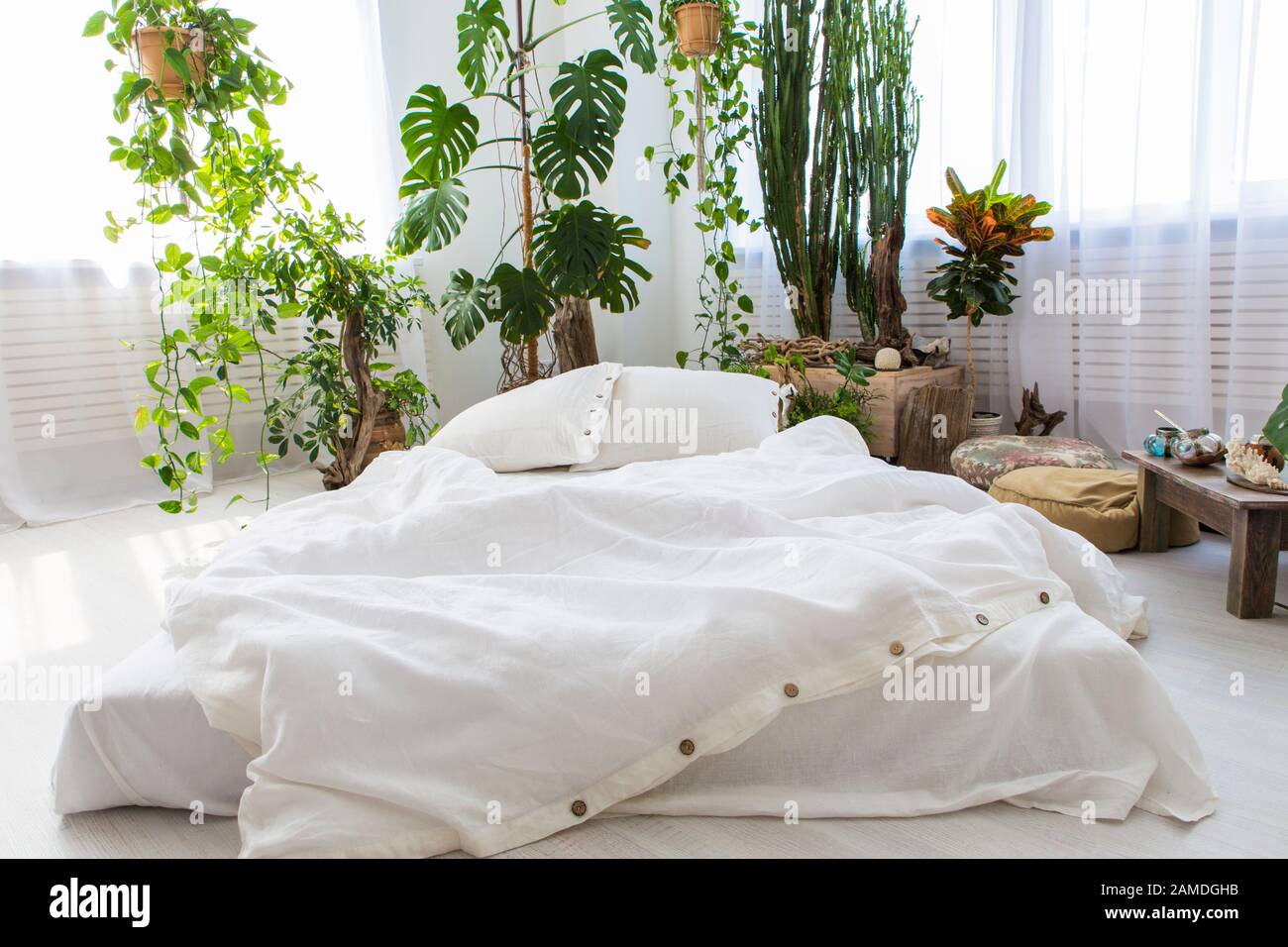 natural ecofriendly linen bed in the interior Stock Photo Alamy