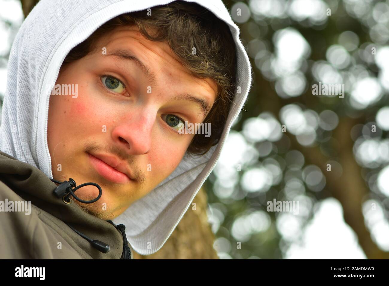 Young Caucasian man wearing hoodie from under jacket. Stock Photo