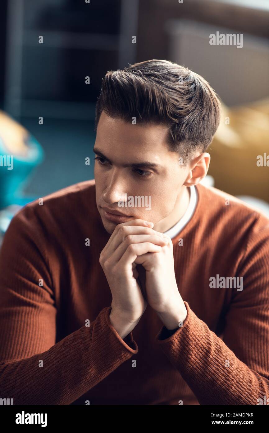 Handsome man feeling thoughtful while having too much work Stock Photo