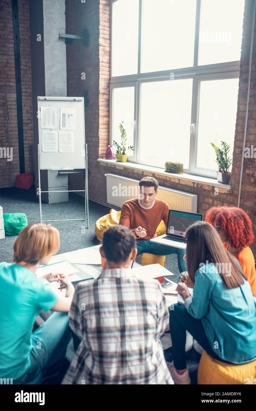 Students sitting in cozy work hub and preparing for group project Stock ...