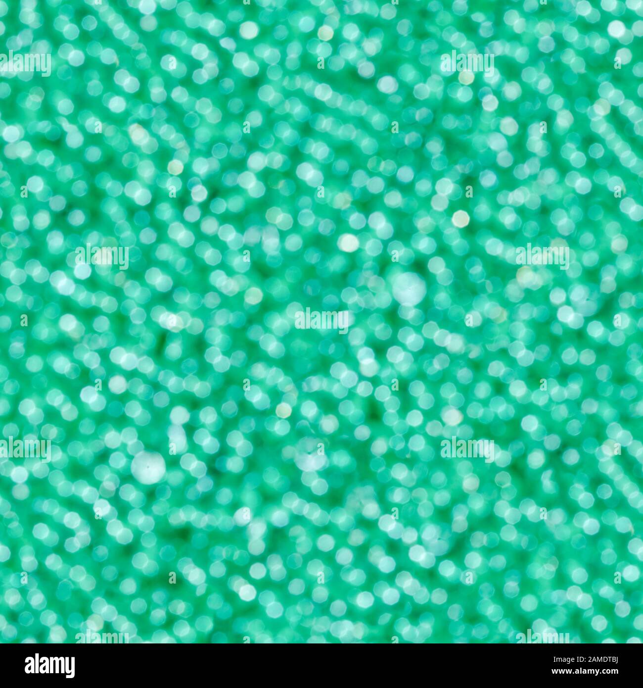 Abstract green light bokeh. Defocused background. Seamless square texture. Stock Photo