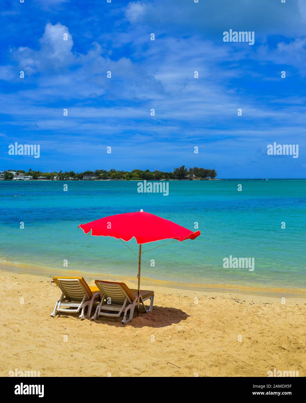 Red umbrella with relaxing chairs on Mauritius Island. Mauritius is one