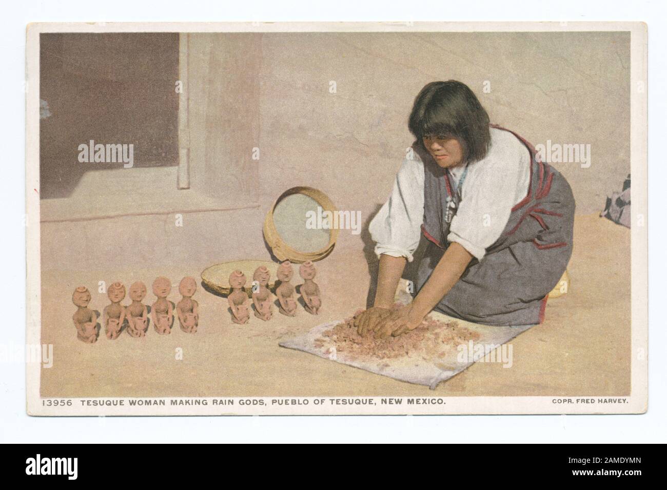 Tesuque Woman Making Rain Gods, Pueblo Tesuque, New Mexico  Postcard series number: 13956 Last series published primarily from company-owned or company-commissioned images.; Tesuque Woman Making Rain Gods, Pueblo Tesuque, New Mexico Stock Photo