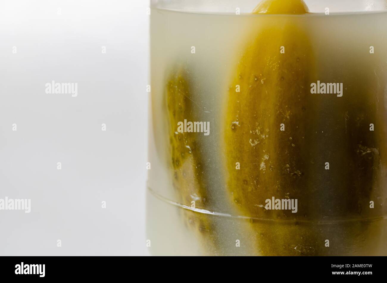 Closeup of tasty cucumbers in a glass jar. Selective focus. Landscape photo arrangement. Stock Photo