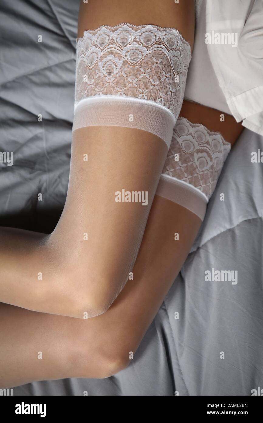 Legs covered from a pair of white stockings Stock Photo - Alamy