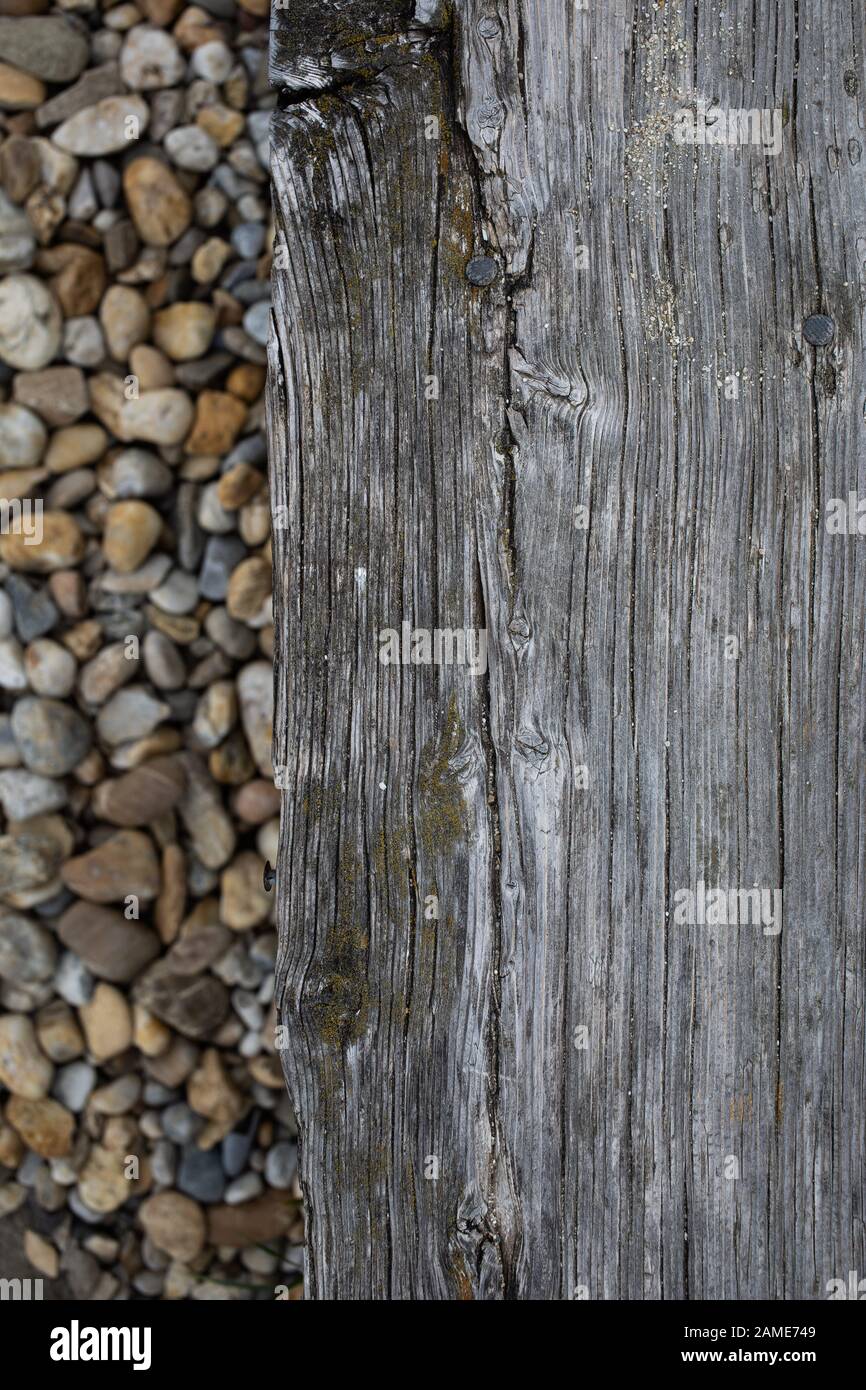 old board and stones on the beach Stock Photo