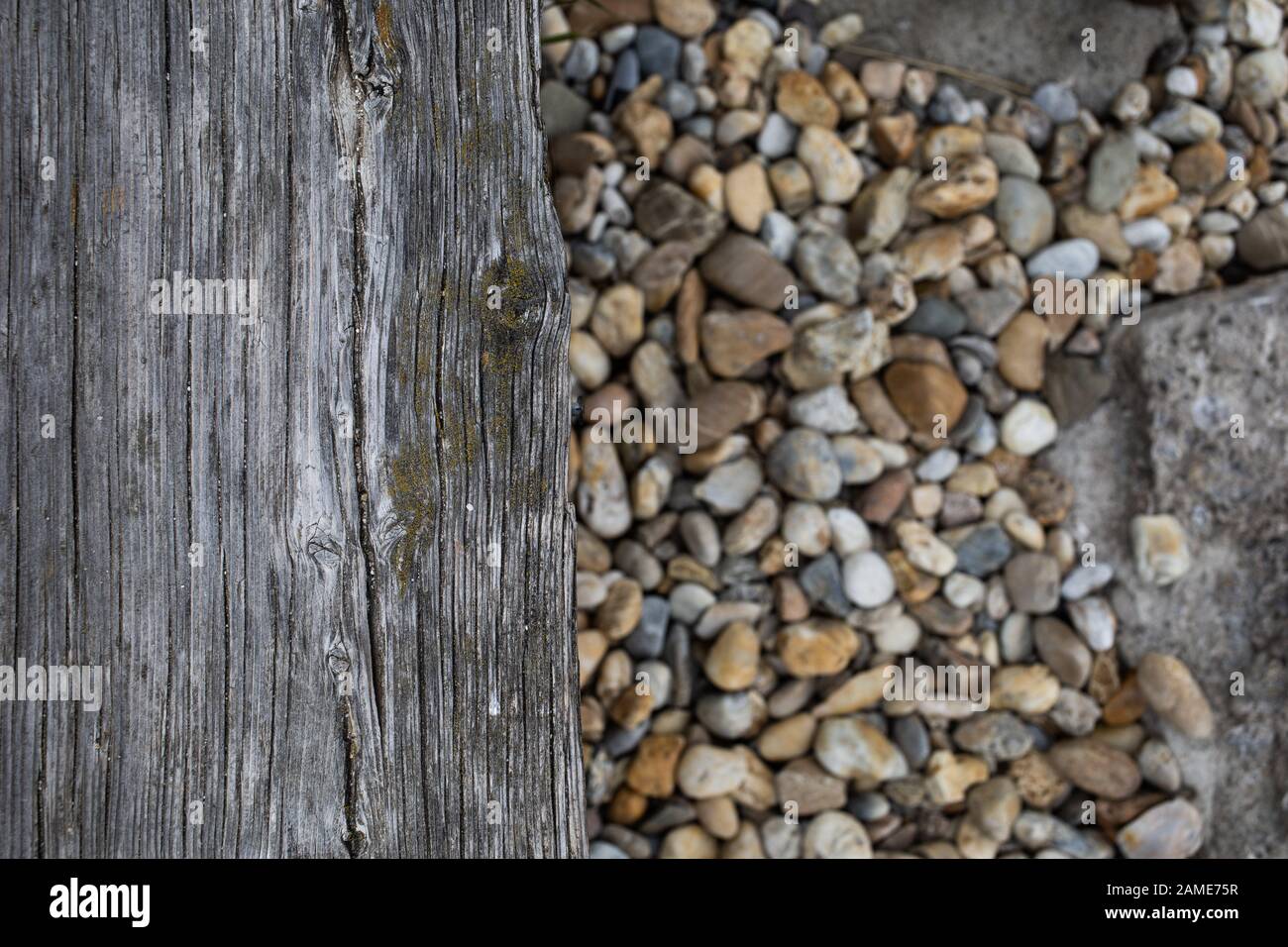 old board and stones on the beach Stock Photo