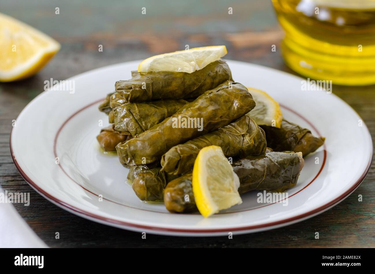 Traditional Turkish Dolma, Sarma or Dolmades,  Eating Traditional Mediterranean Dish Dolmadakia or Stuffed Grapes Leaves on Rustic Background Stock Photo
