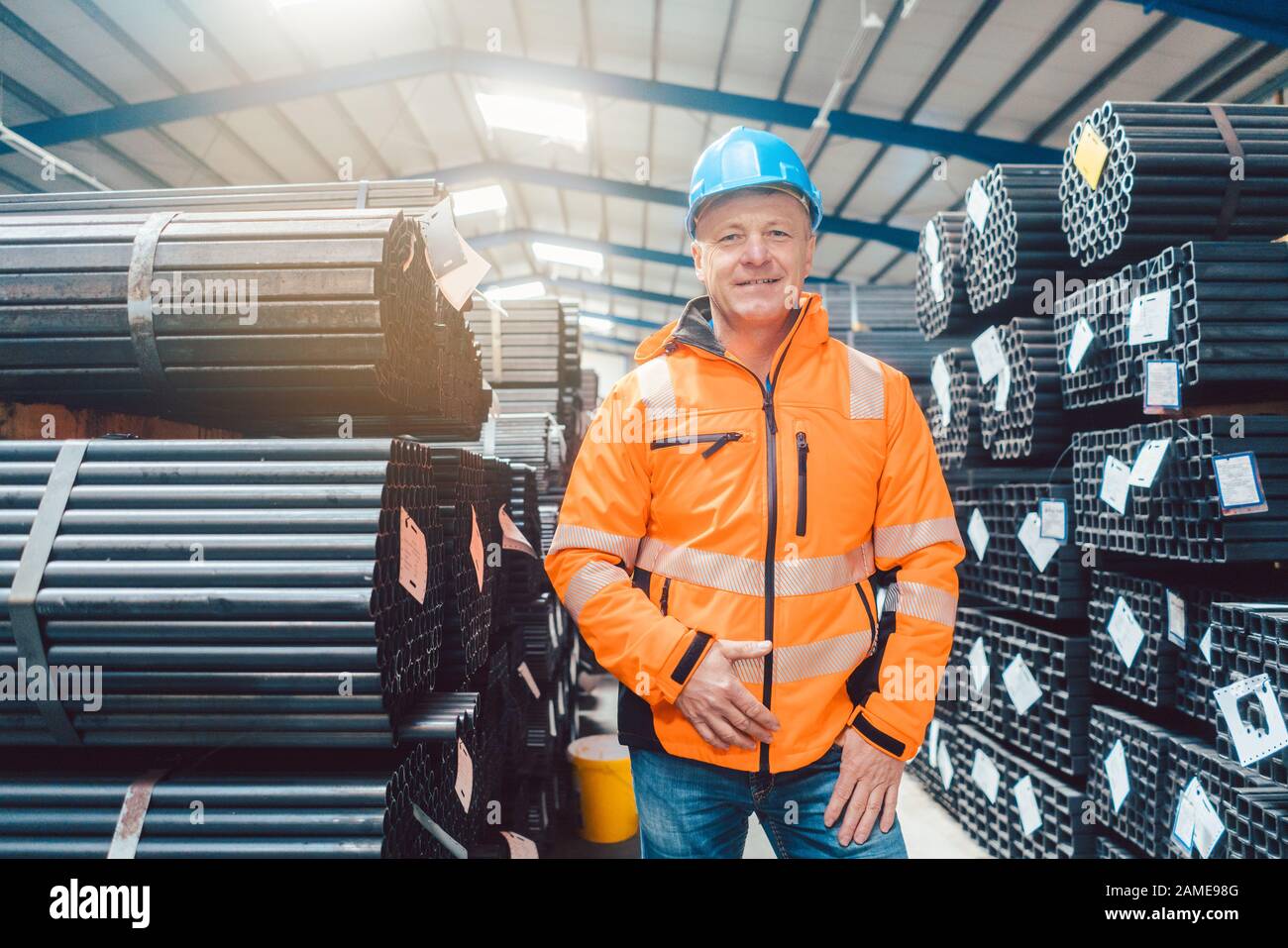 Worker in distribution center for metal and building materials Stock