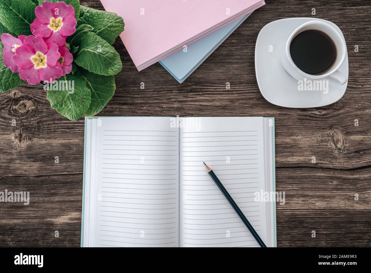 Pencil And An Open Notebook On Wooden Table With Nice Decoration