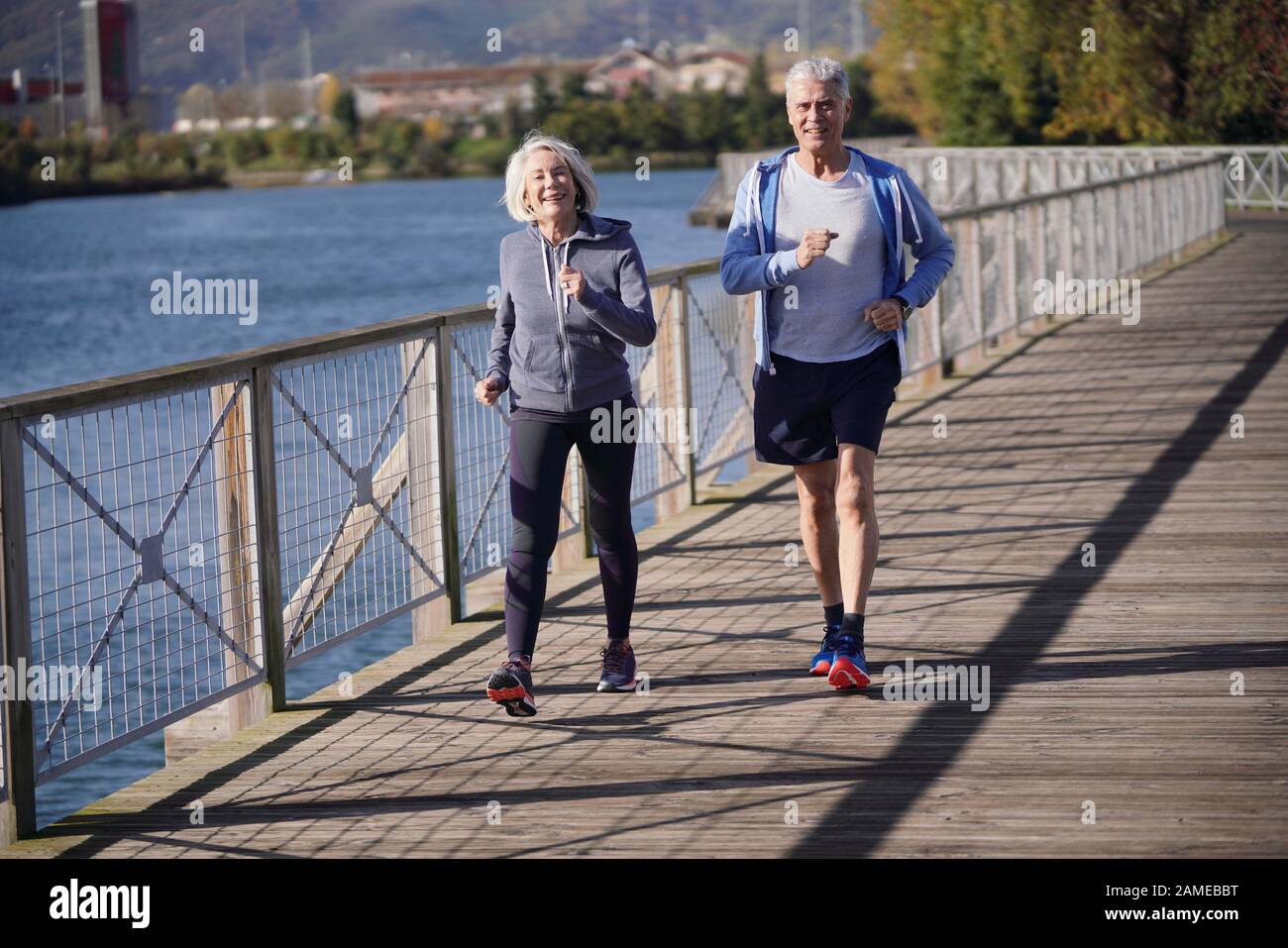 Active senior couple speed walking together on bridge Stock Photo Alamy