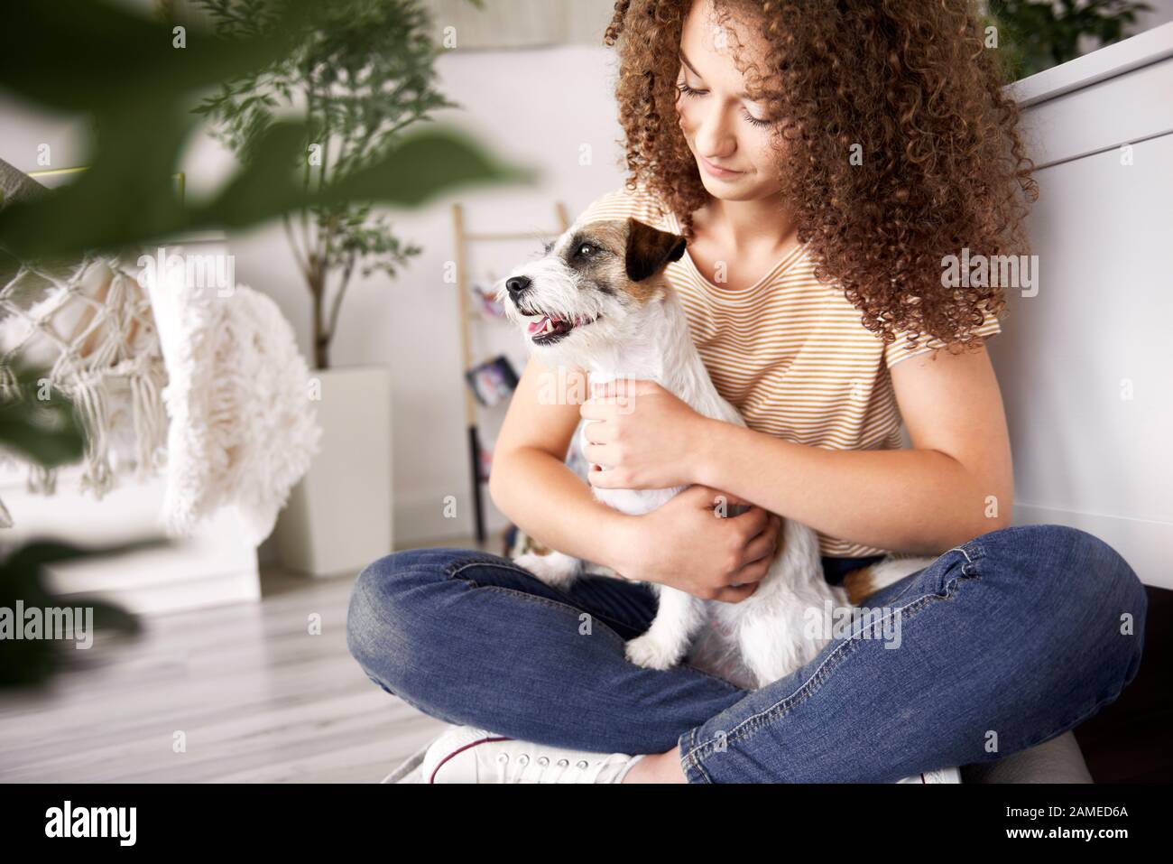 Teenage girl and dog in her room Stock Photo - Alamy