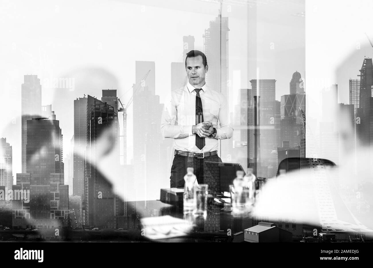 Confident company leader on business meeting against new york city manhattan buildings and skyscrapers window reflection. Stock Photo