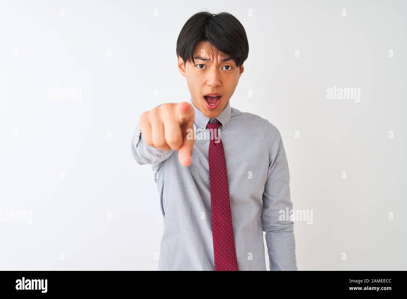Chinese businessman wearing elegant tie standing over isolated white ...