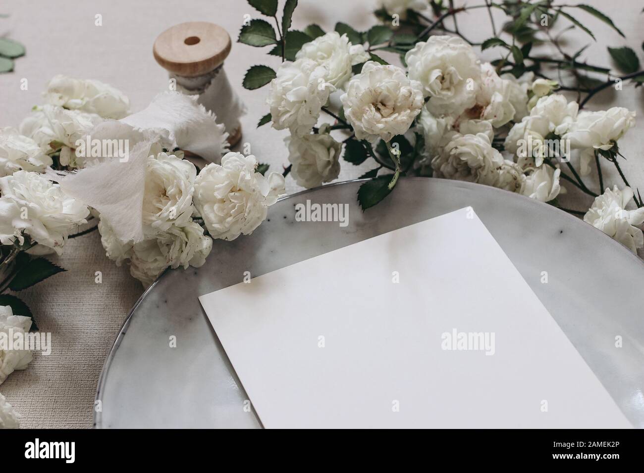 Download Closeup Of Blank Greeting Card Moody Wedding Table Mockup Scene Feminine Desktop Composition With Fading White Rose Flowers Plate And Silk Ribbon Stock Photo Alamy