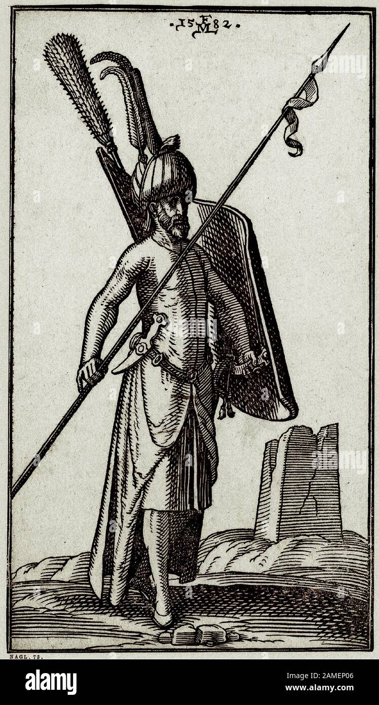 The history of Ottoman Empire. A Turkish soldier is holding a lance in his right hand and a shield in his left hand; wearing a turban decorated with l Stock Photo