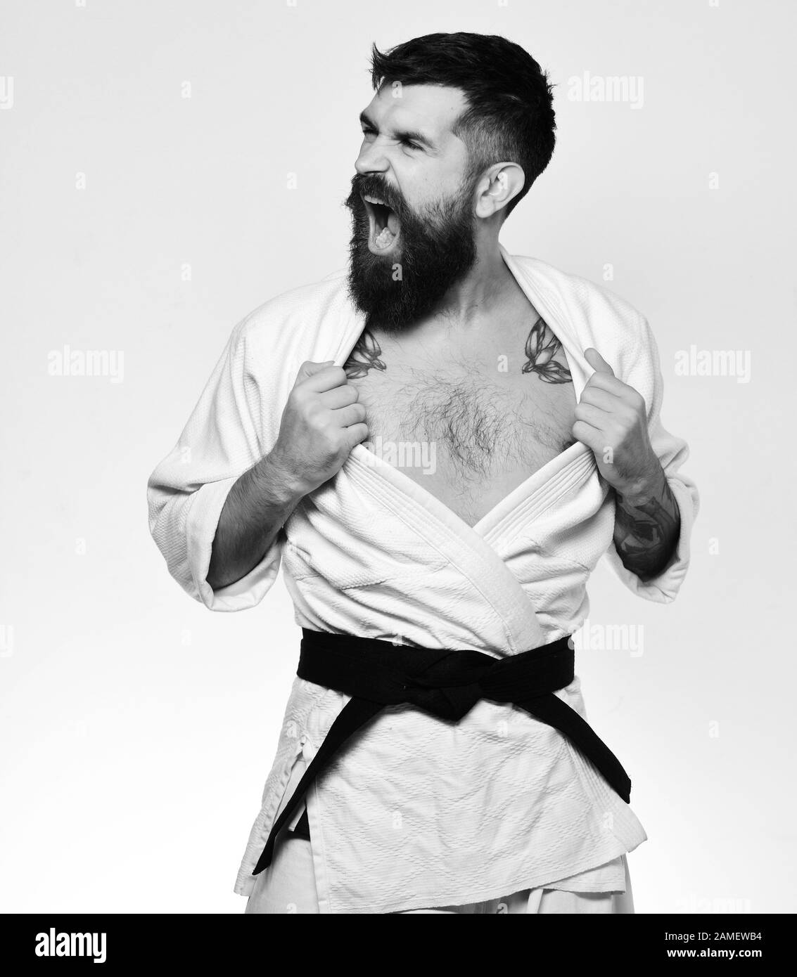 Japanese martial arts concept. Man with beard in white kimono on white