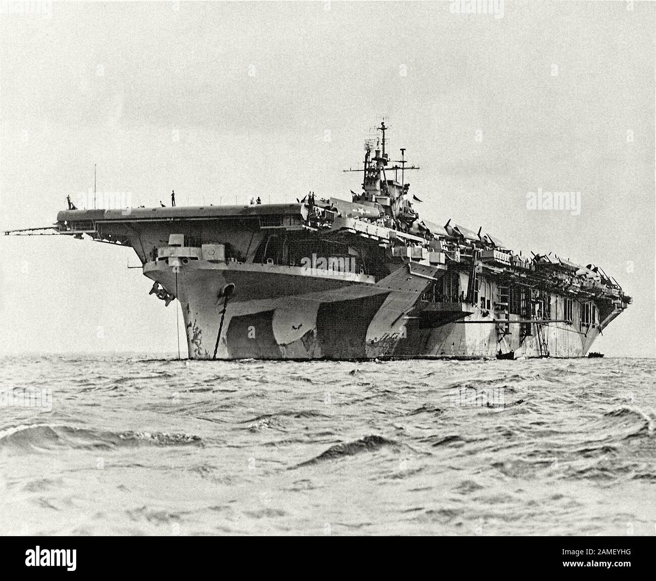 The American “Yorktown” aircraft carrier (USS Yorktown CV-10), anchored at the atoll of Majuro. On the deck of Yorktown aircraft carrier are aircraft Stock Photo