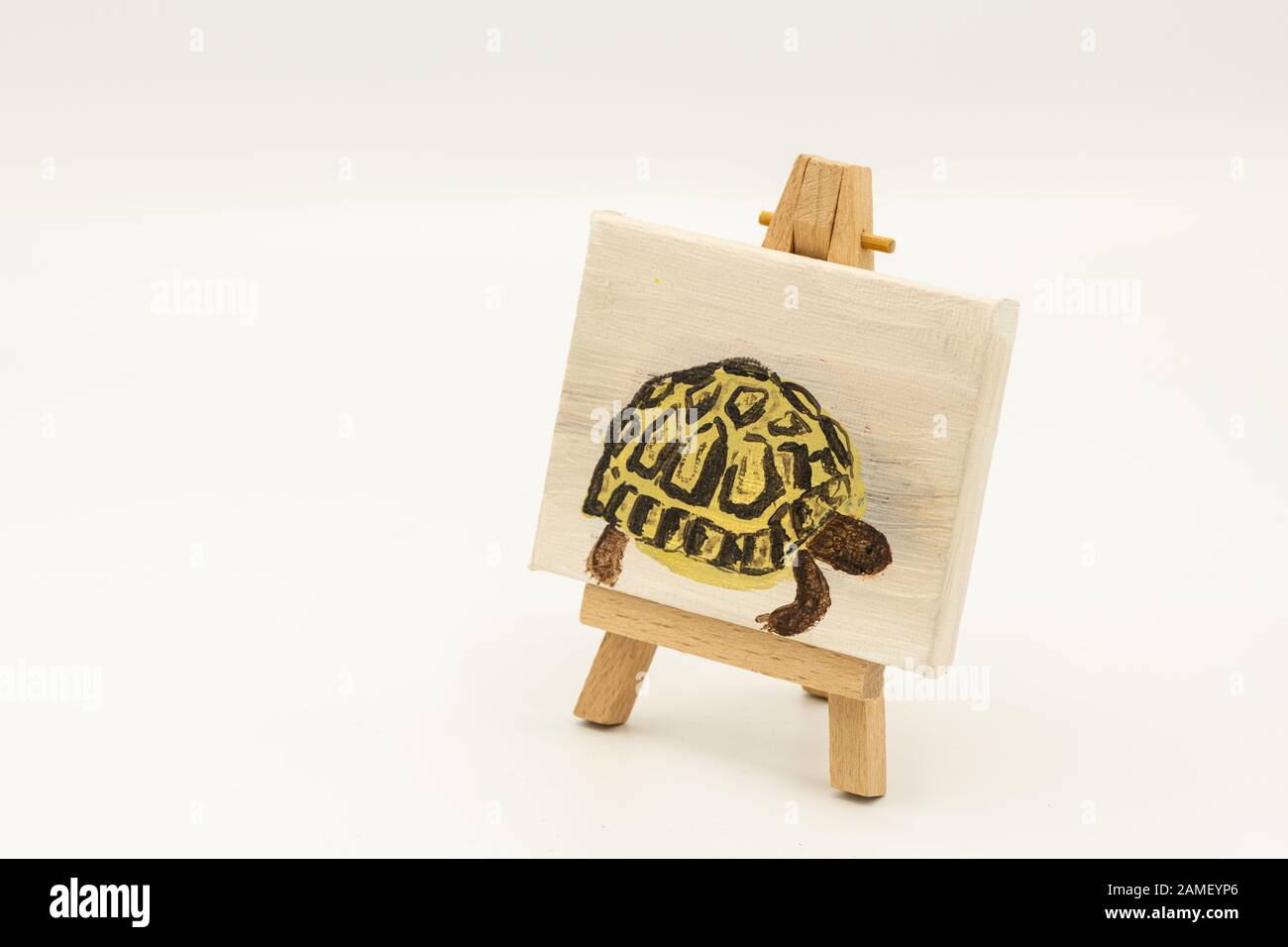 Closeup of a small child's painting of a tortoise on an easel Stock Photo