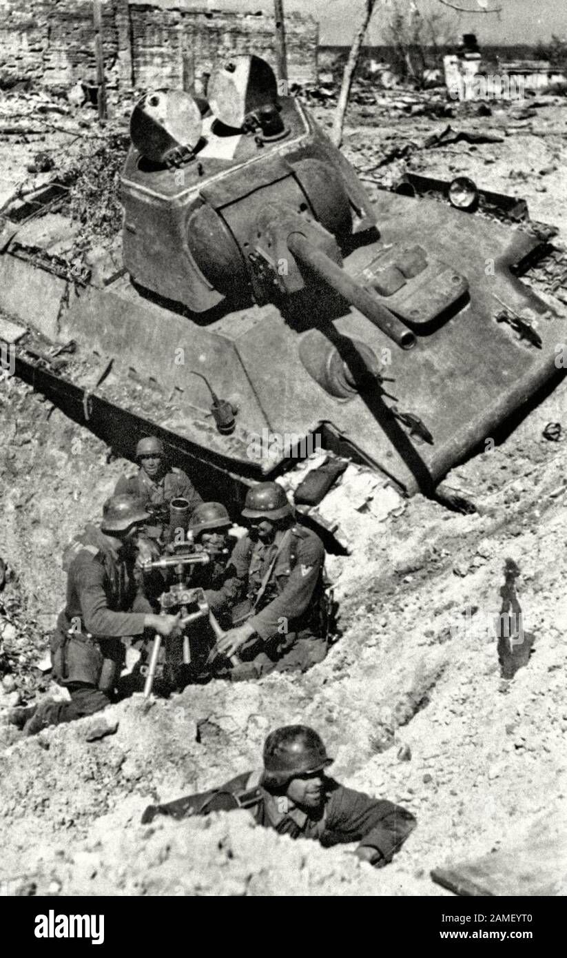 German mortar crew of 24 Wehrmacht Panzer Division is preparing to open fire during the Battle of Stalingrad. The firing position is equipped in the f Stock Photo