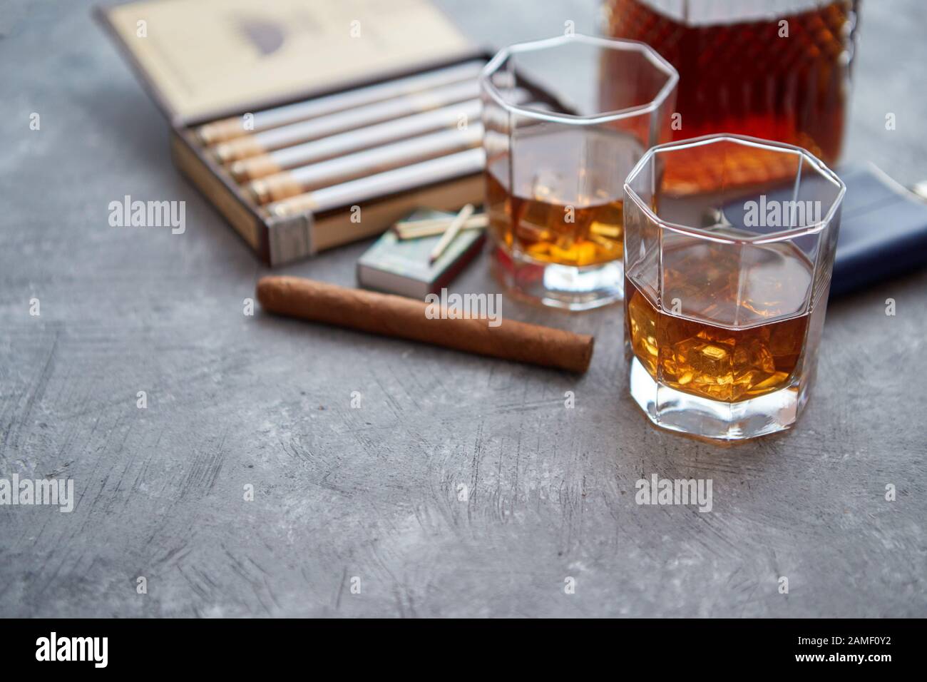 Carafe of Whiskey or brandy, glasses and box of finnest Cuban cigars Stock Photo