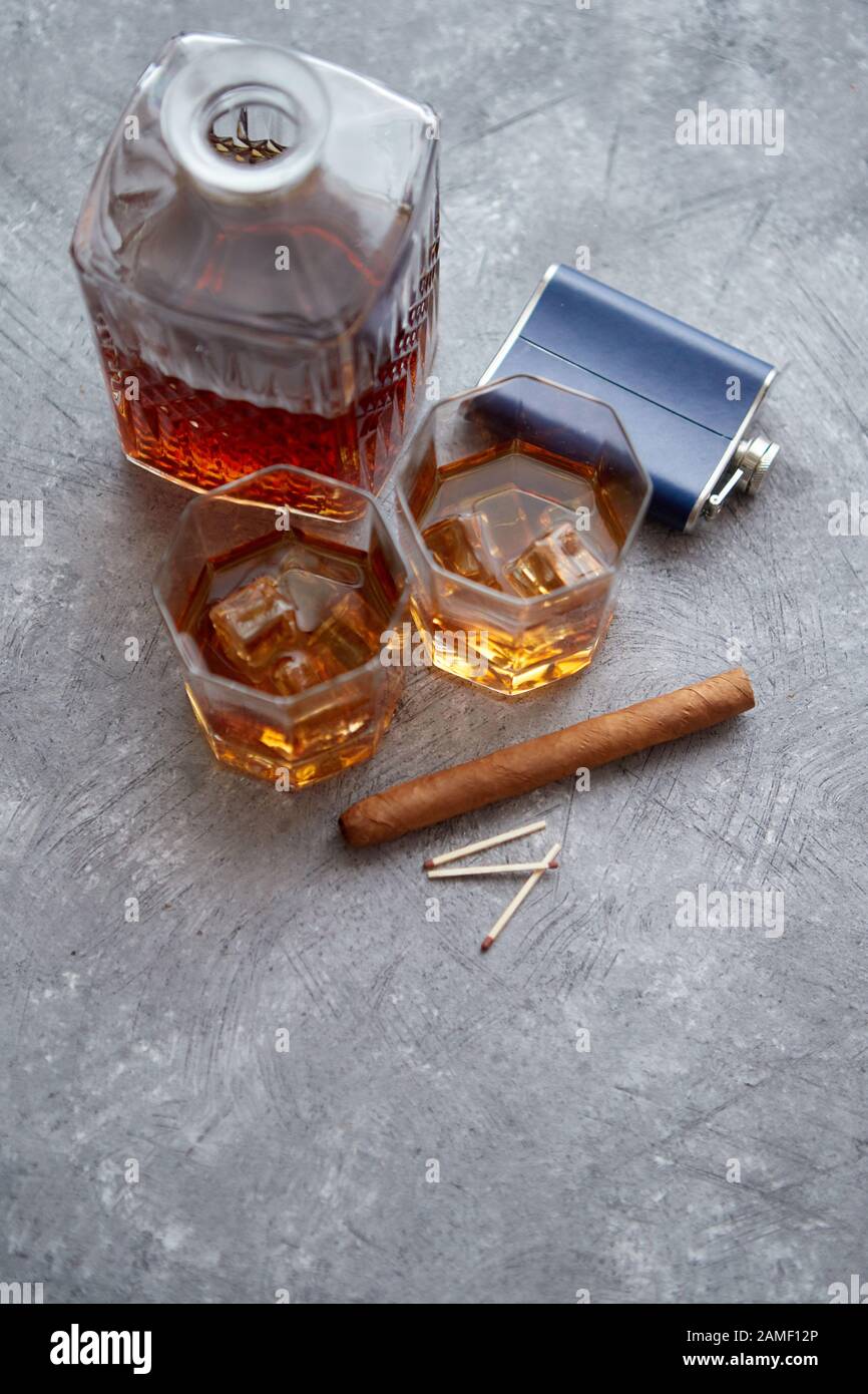 Two glasses of old whiskey with cuban cigar and carafe Stock Photo