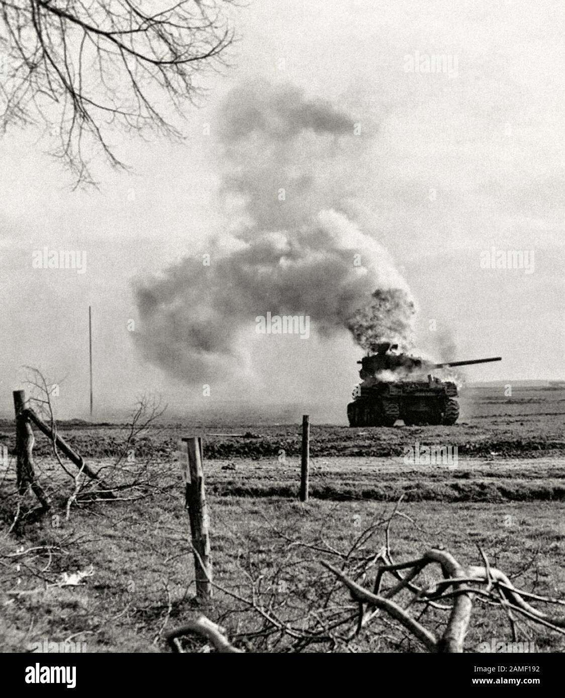 Burning M4A1 (76) W “Sherman” medium tank from the 3rd US tank division, destroyed by German artillery in Bergerhausen, Kerpen, Germany. March 01, 194 Stock Photo