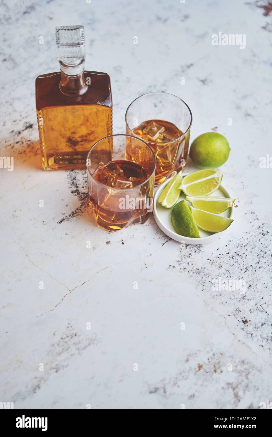 Whiskey sour drink with lemon in glass on stone rustical background Stock Photo