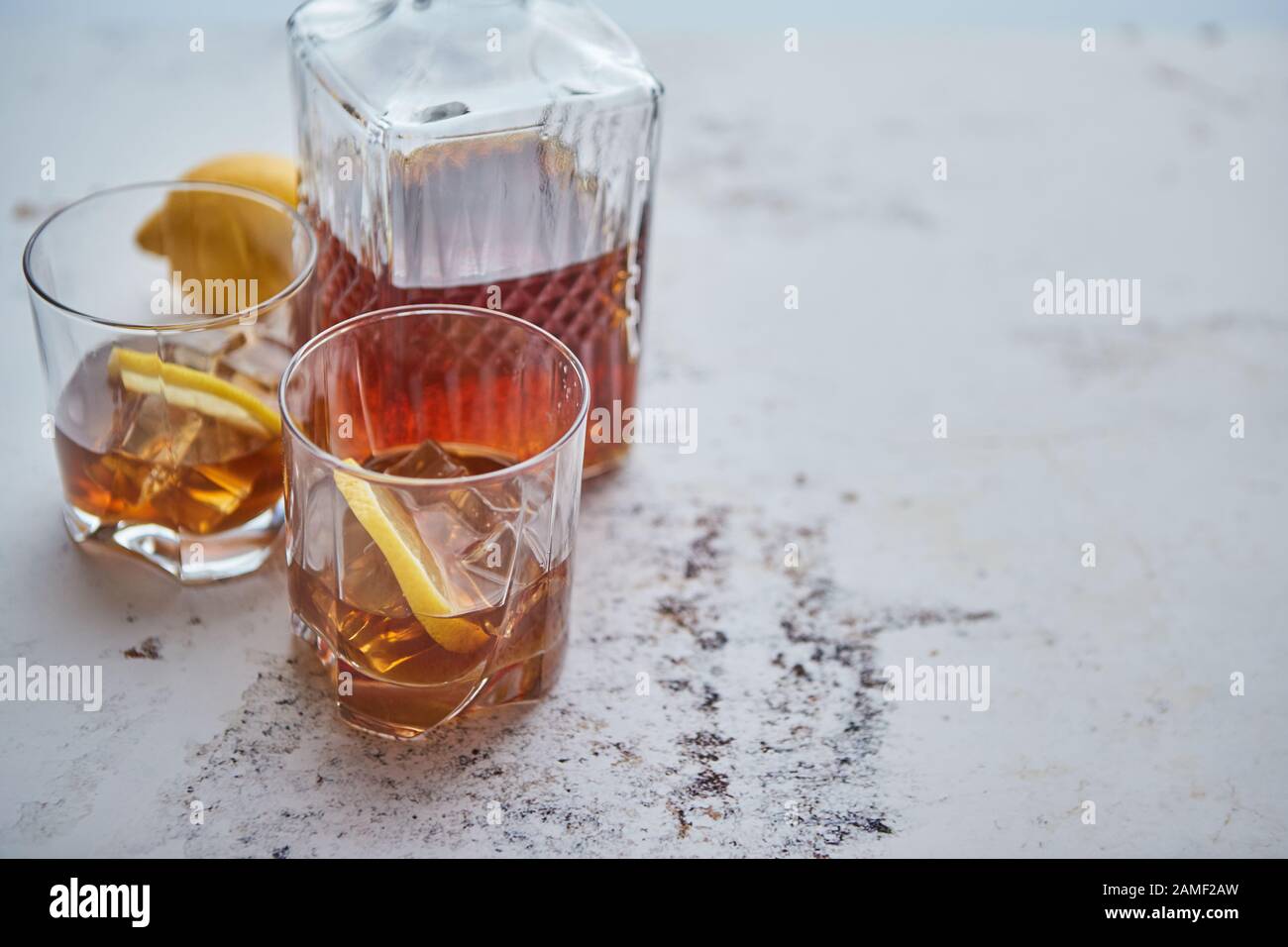 Whiskey sour drink with lemon in glass on stone rustical background Stock Photo