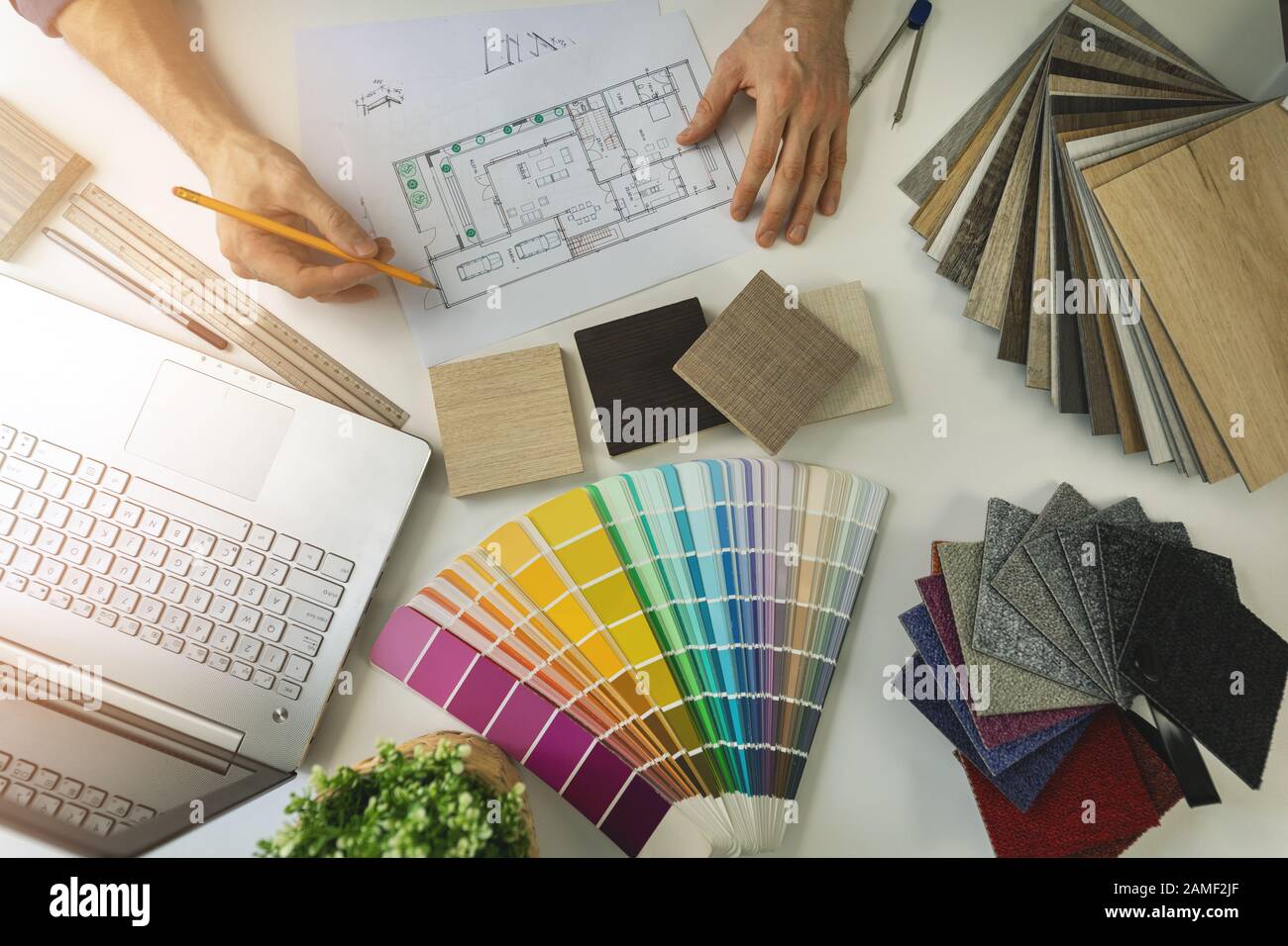 designer working in office doing furniture and flooring material selection from samples for home interior design project. top view Stock Photo