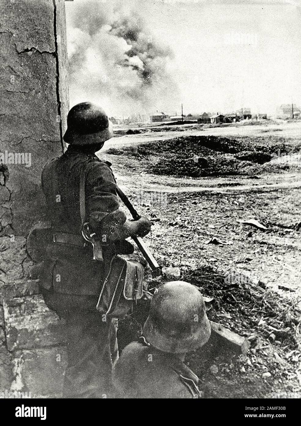 German soldiers watch as German guns pond Stalingrad. 1942. Stock Photo