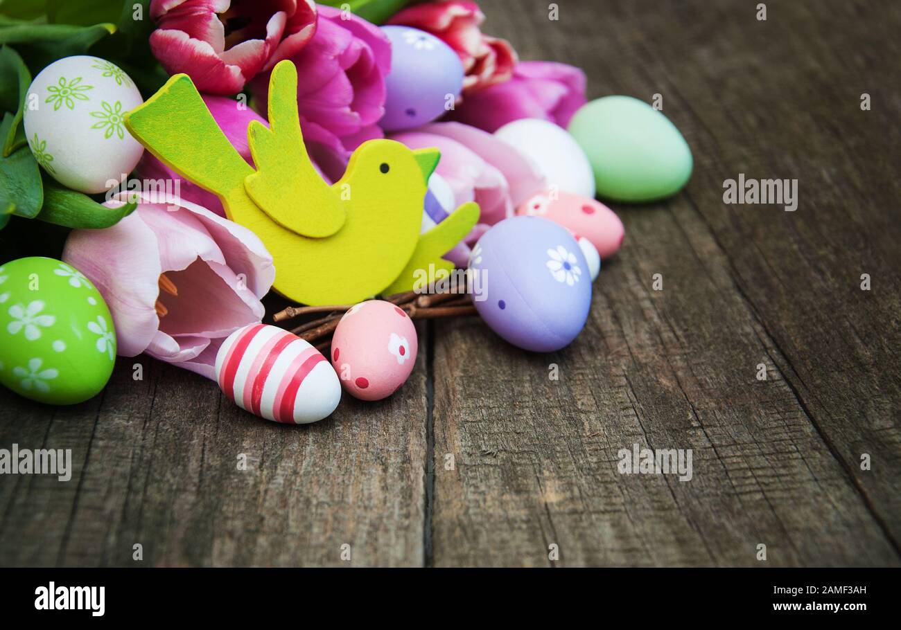 Easter eggs and tulips on a old wooden background Stock Photo - Alamy