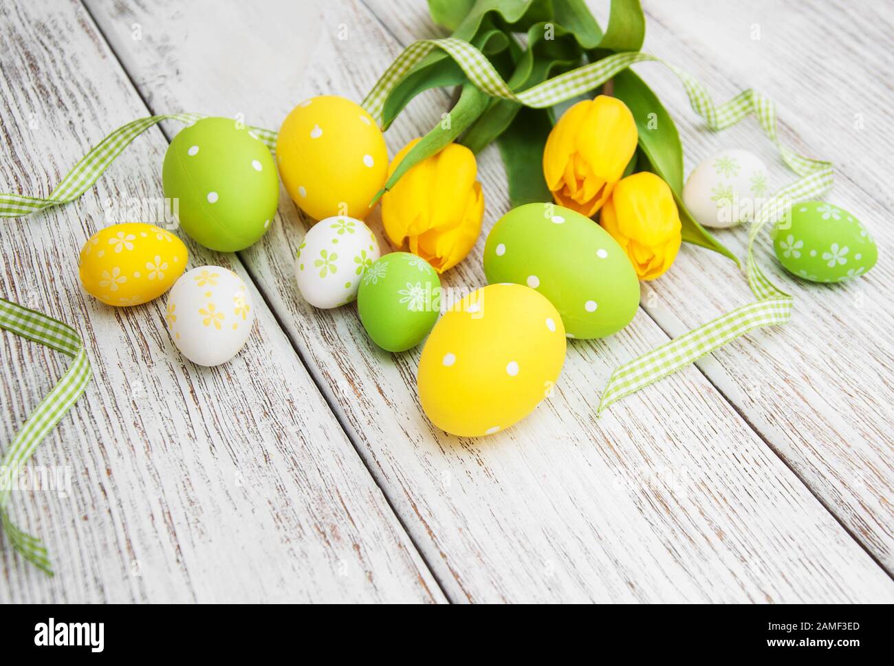 Easter eggs and tulips on a old wooden background Stock Photo - Alamy