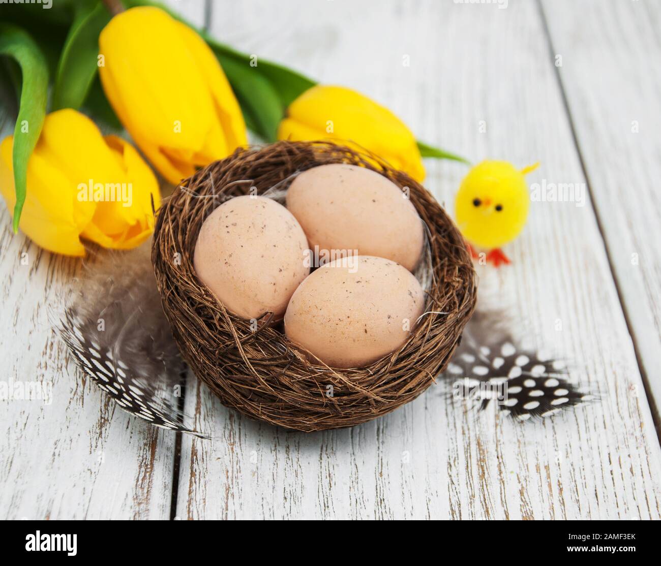 Easter eggs and tulips on a old wooden background Stock Photo - Alamy