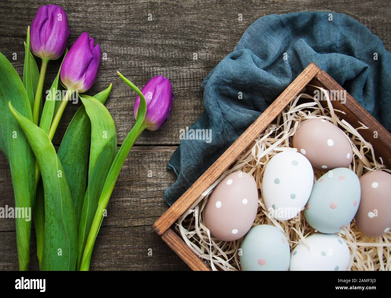 Easter eggs and tulips on a old wooden background Stock Photo - Alamy