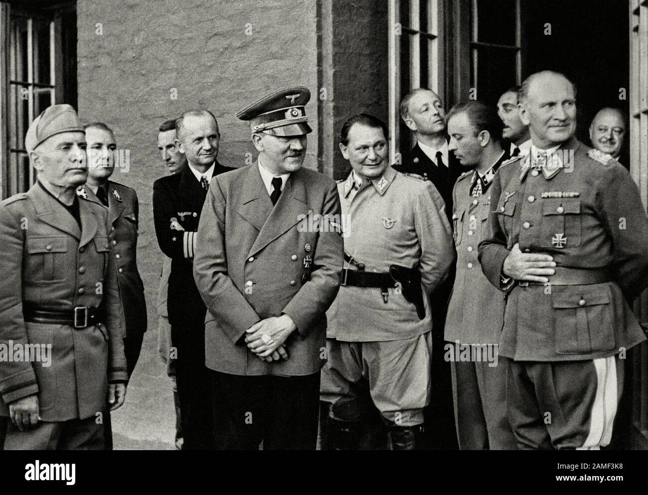 Photo of meeting between Mussolini and Hitler. 1944 On the photograph are: Mussolini, Hitler, behind Mussolini,  Martin Bormann. Next to him stands th Stock Photo