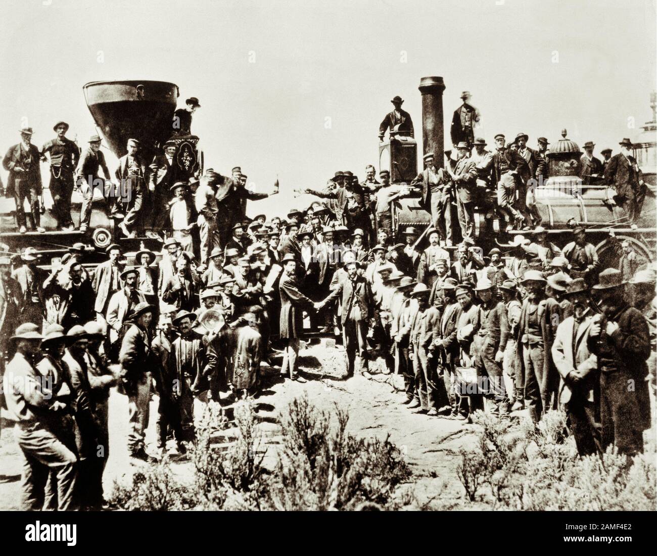 Railroad workers gather in Promontory, Utah, to celebrate the completion of the first Transcontinental Railroad on May 10, 1869. Stock Photo