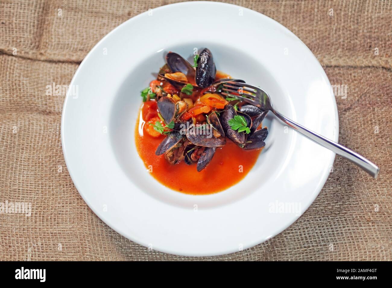 blue mussels in tomato white wine brew Stock Photo